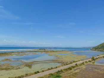 Scenic view of beach against blue sky