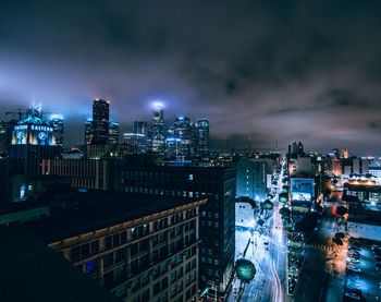 High angle view of city lit up at night