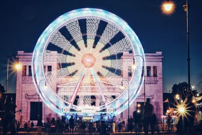 Low angle view of illuminated ferris wheel at night