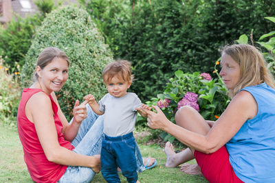 Happy family sitting in garden