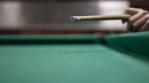 Cropped hand of man playing pool