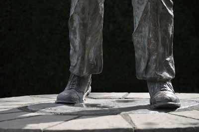 Low section of man standing on footpath