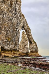 Ancient structure against cloudy sky