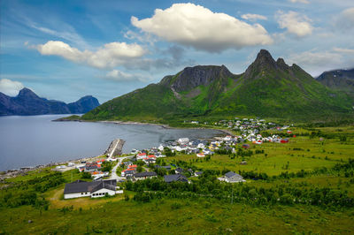 Scenic view of sea and mountains against sky