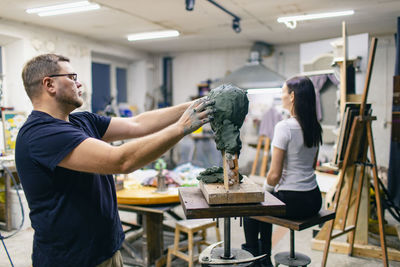 Side view of man working in workshop