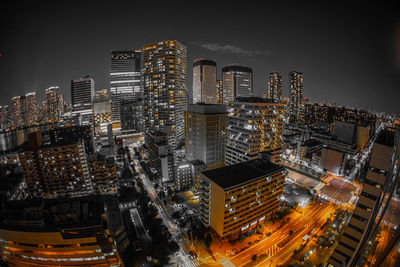 High angle view of illuminated buildings against sky at night