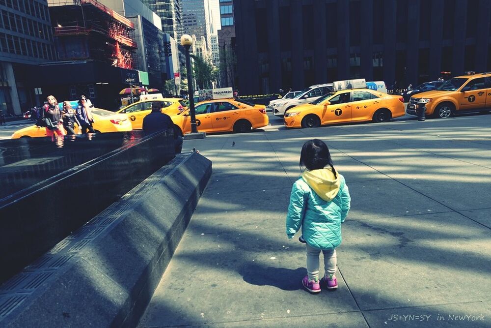 WOMAN WALKING ON CITY STREET