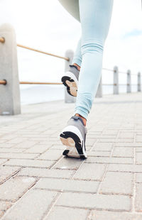 Low section of man walking on footpath