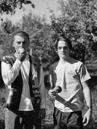 Portrait of smiling friends standing in park