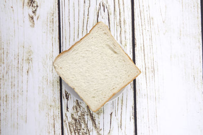 Directly above shot of bread slice on wooden table