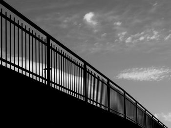 Low angle view of footbridge against sky