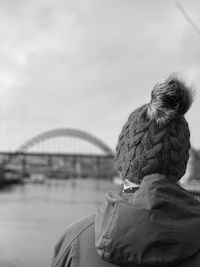 Rear view of woman wearing a knit hat on the river tyne