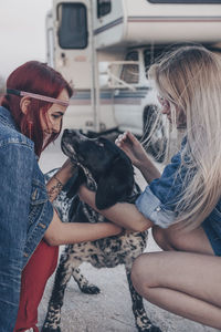 Side view of young woman with dog