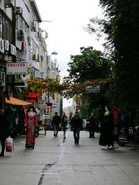 People in city against sky