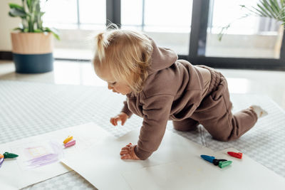 High angle view of boy drawing on table