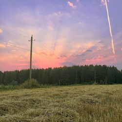 Scenic view of field against cloudy sky