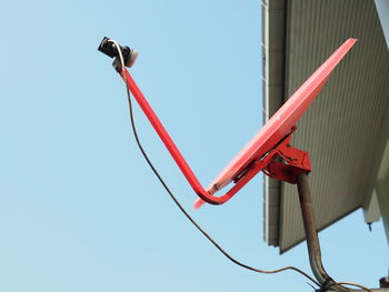 Low angle view of satellite dish against clear blue sky