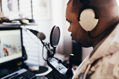 Close-up of disabled musician with headphones in studio