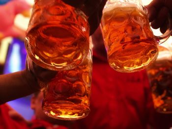 Close-up of hand holding beer glass