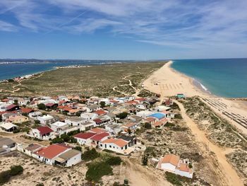 High angle view of buildings by sea against sky