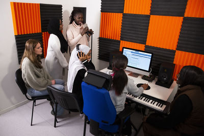 Portrait of singers and composers working in recording studio