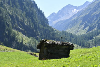 Built structure on field against mountain range