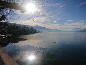 Scenic view of lake against bright sun