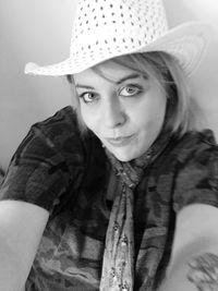 High angle portrait of young woman wearing hat at home