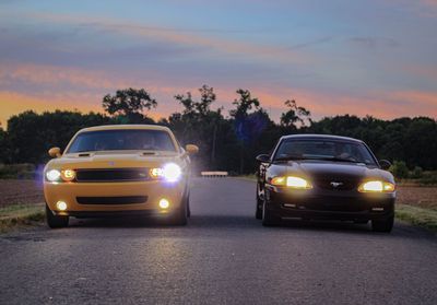 Car on road at sunset