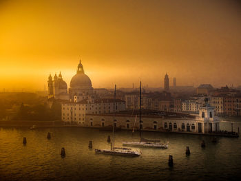 View of mosque in city at sunset