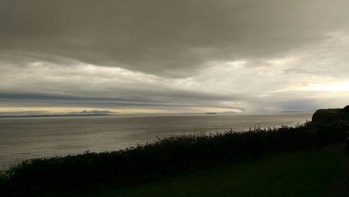 Scenic view of sea against cloudy sky