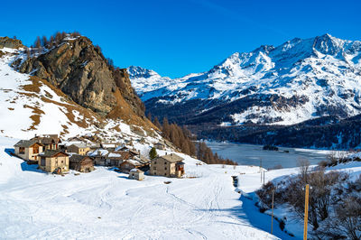 View of the village of grevasalvas, and lake sils, in engadine, switzerland, in winter.