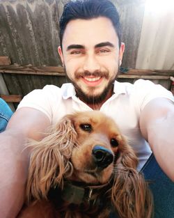 Low angle portrait of smiling man with dog