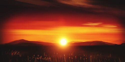 Scenic view of silhouette mountains against sky during sunset