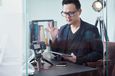 Businessman recording content on camera