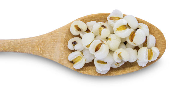 Close-up of cake on cutting board against white background