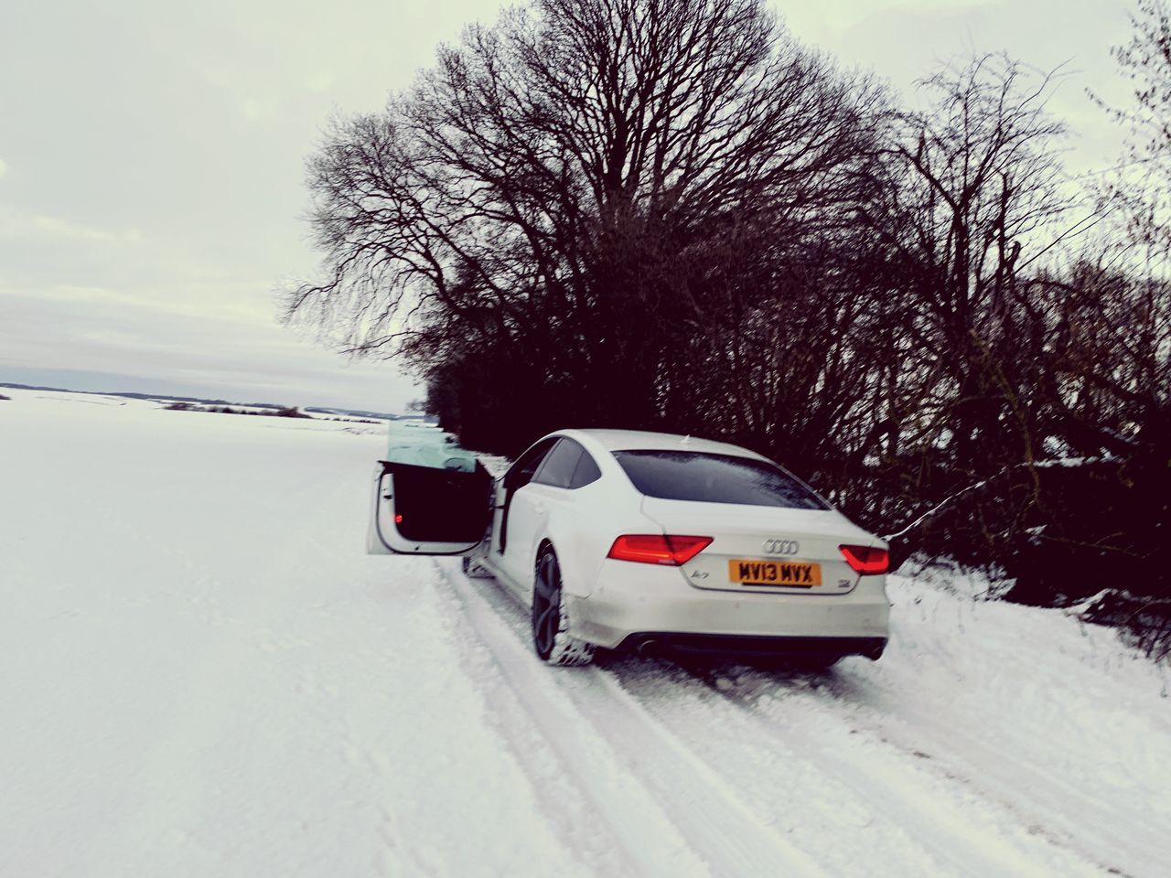 SNOW COVERED CAR ON ROAD