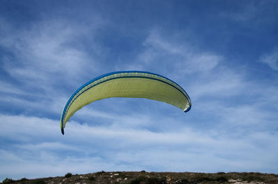 Low angle view of parachute against sky