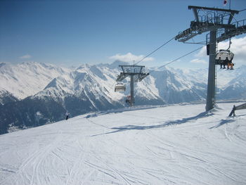 Ski lift over snow covered mountains