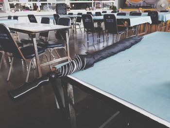 Empty chairs and tables in swimming pool