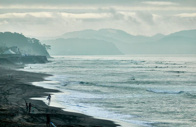 Scenic view of sea against sky in foggy morning