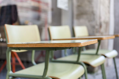 Close-up of empty chairs on table