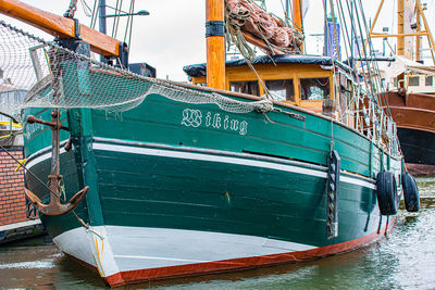 Fishing boats moored at harbor