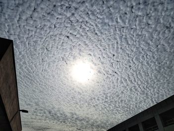 Low angle view of building against sky on sunny day