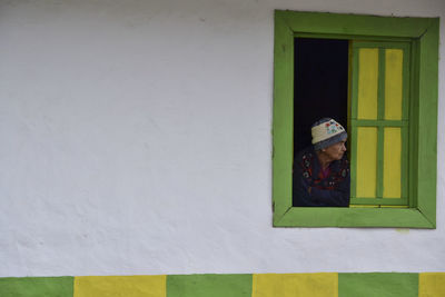 Close-up of woman against window