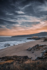 Scenic view of beach against sky during sunset