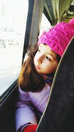 Portrait of cute girl in car