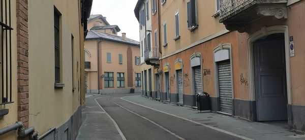 Empty alley amidst buildings in city