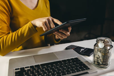 Midsection of man using mobile phone