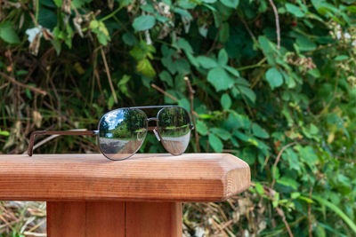 Close-up of sunglasses on a bench 